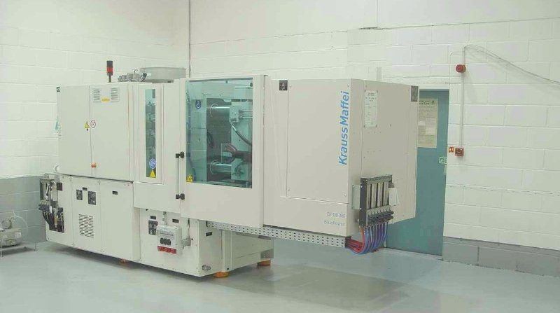 A large machine is sitting in a room next to a door.