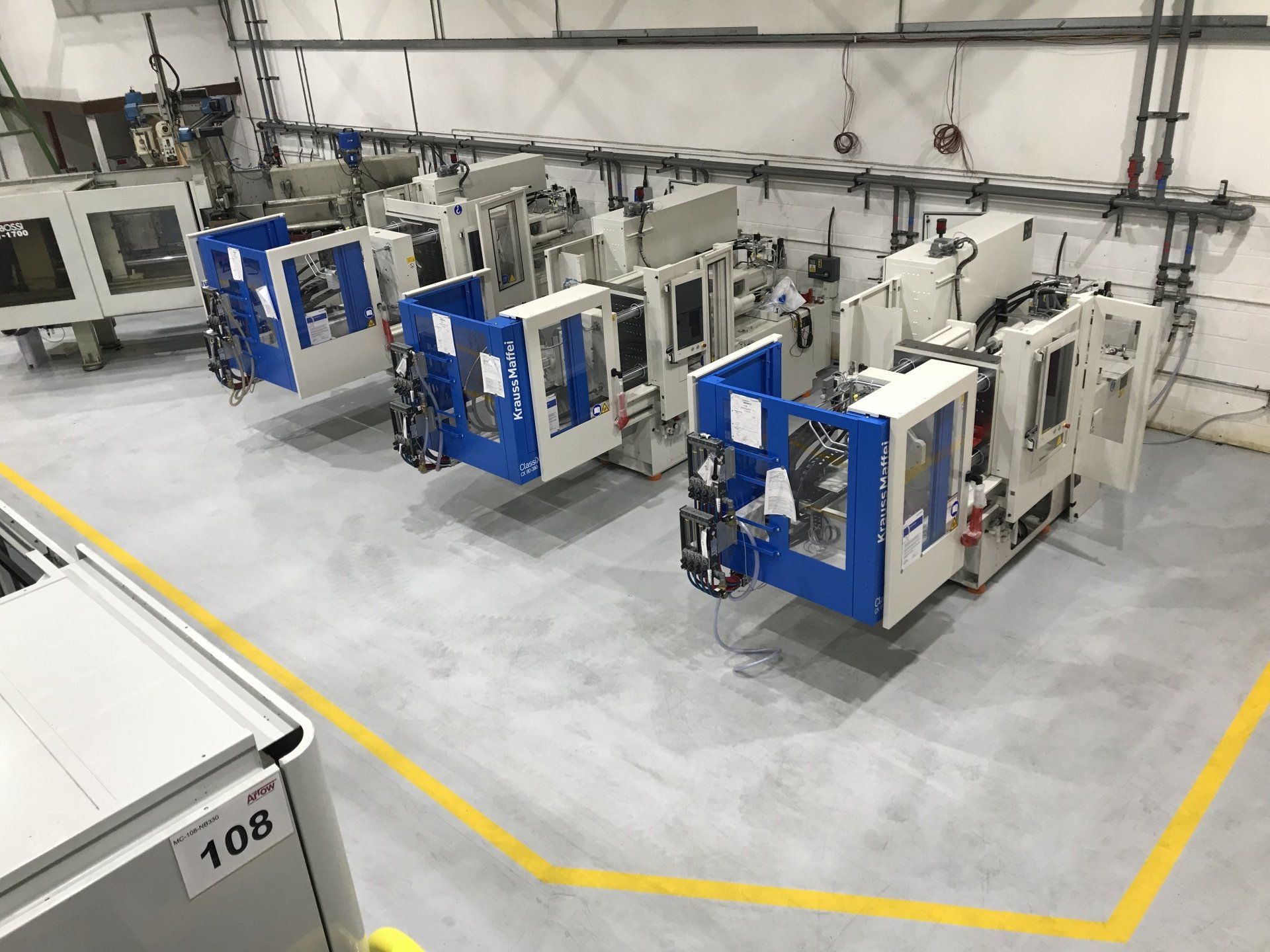 A row of machines are lined up in a factory.