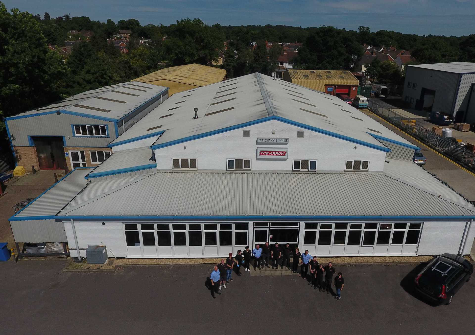 A group of people are posing for a picture in front of a large building.