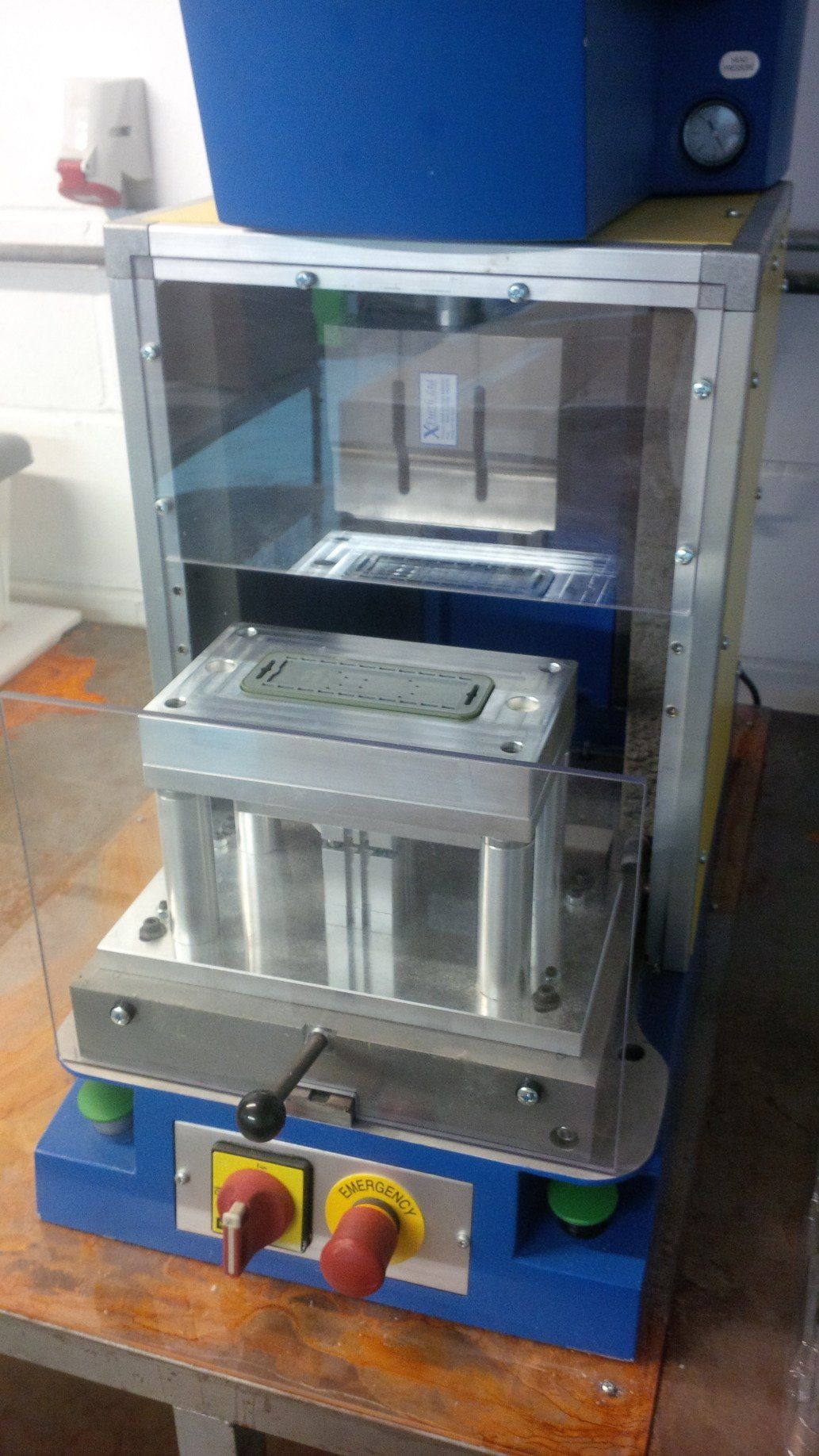 A machine is sitting on top of a wooden table.