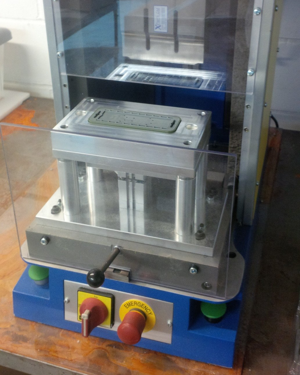 A machine is sitting on top of a wooden table