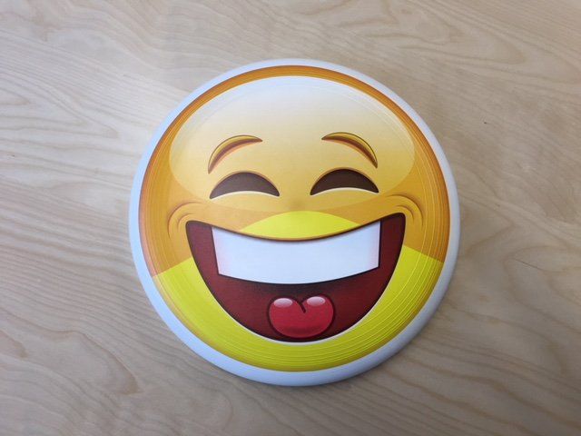 A smiley face with its mouth open and tongue sticking out