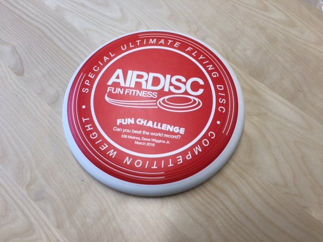 A red and white frisbee that says airdisc on it