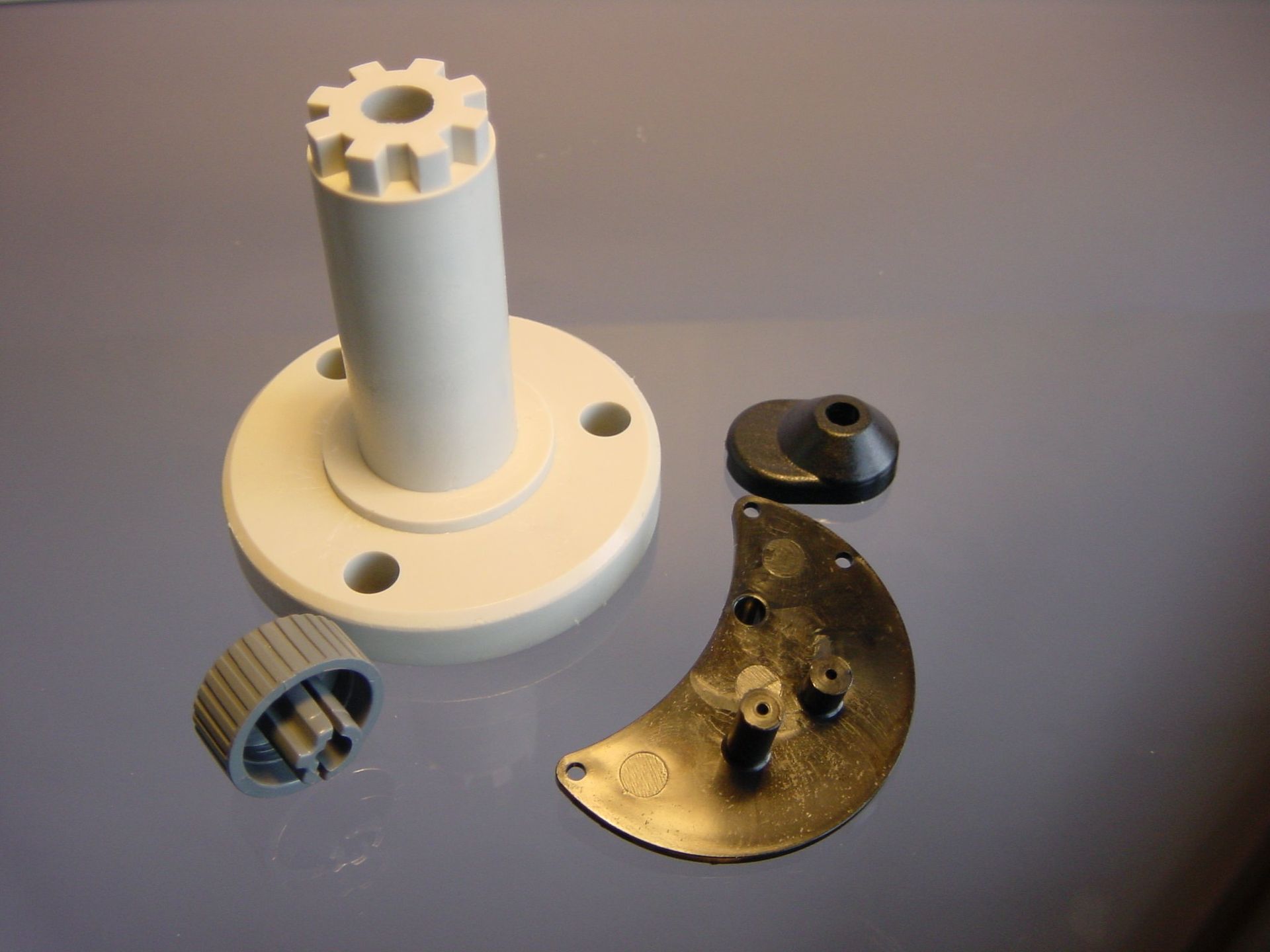 A white cylinder with a gear on top of it