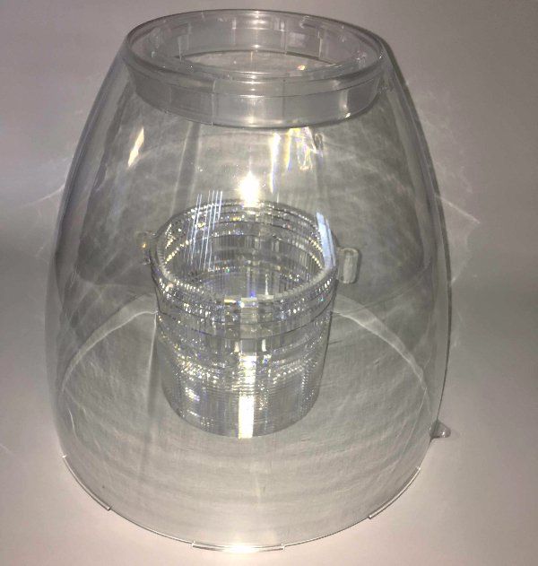A clear plastic container with a glass inside of it