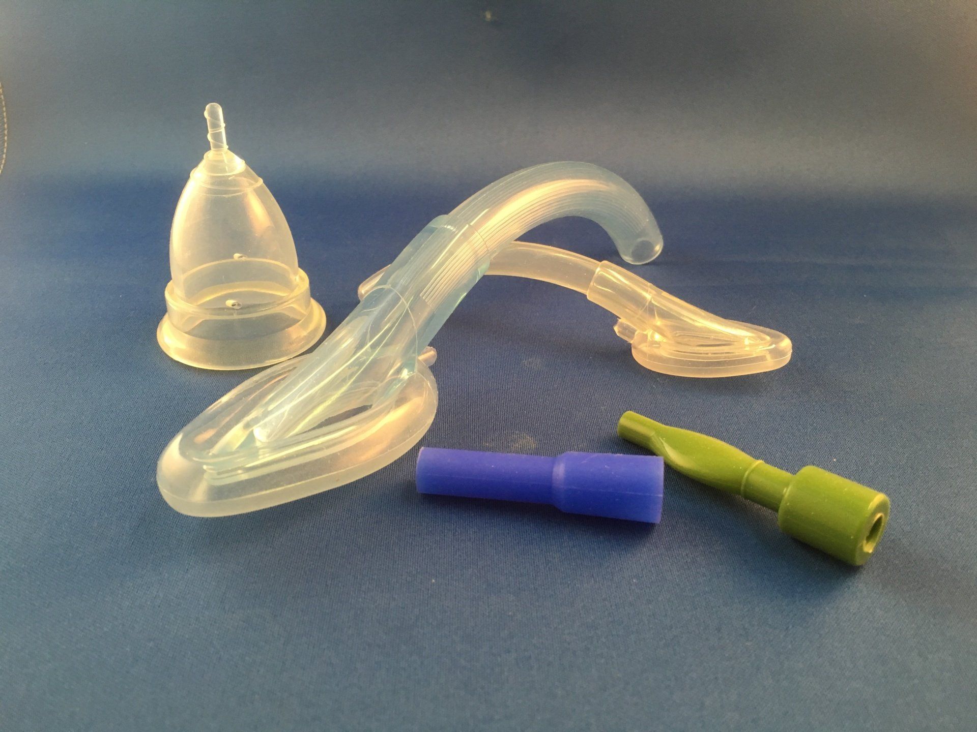 A group of clear plastic objects on a blue surface