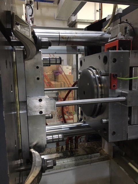 A machine in a room with boxes in the background