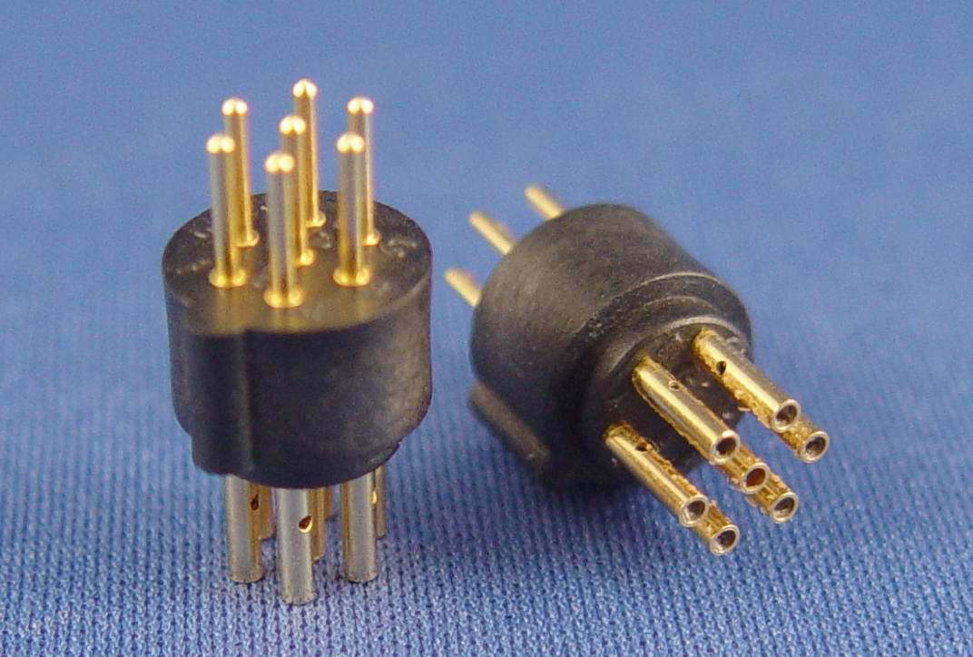 Two black and gold connectors on a blue cloth