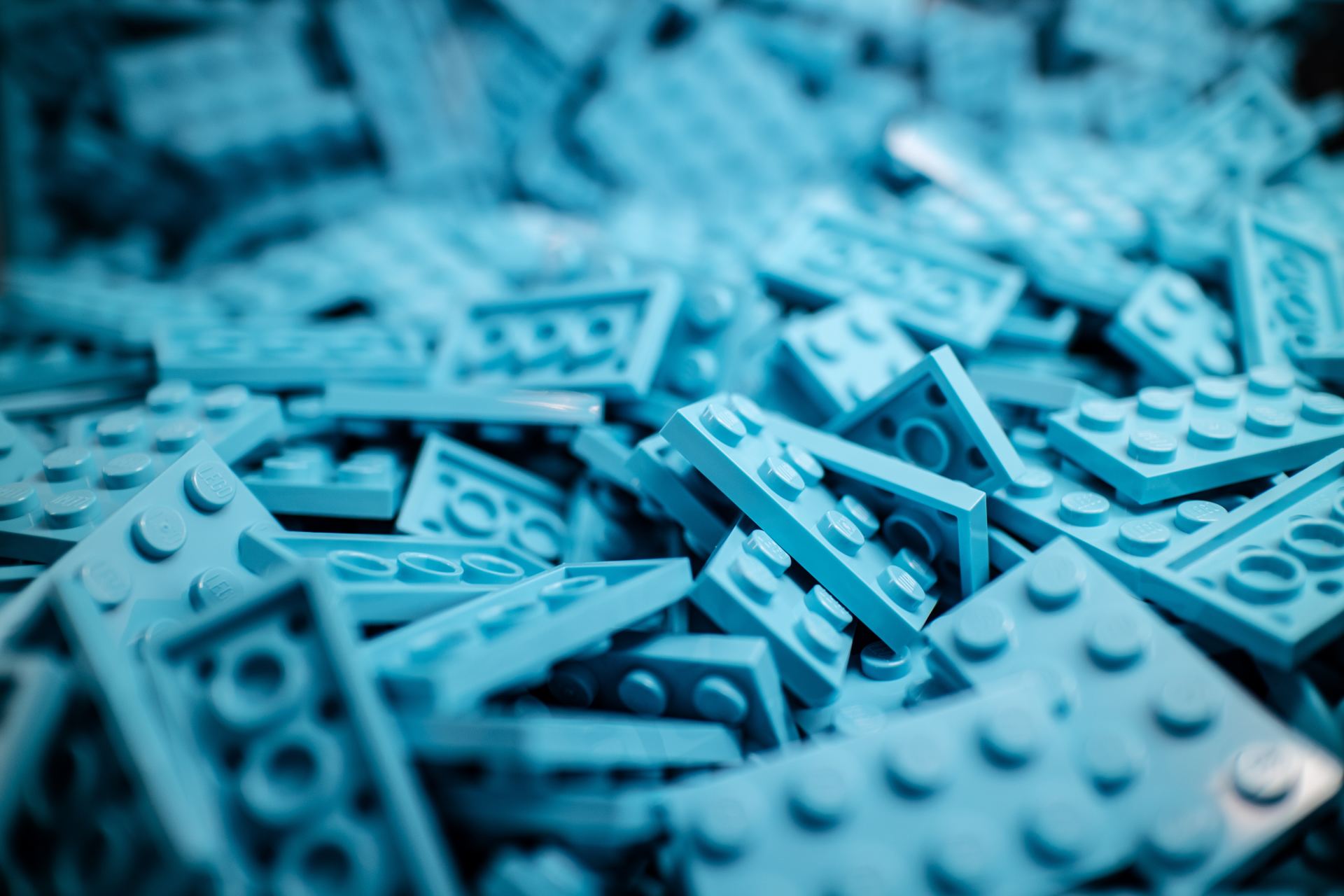 A pile of blue lego bricks on a table.