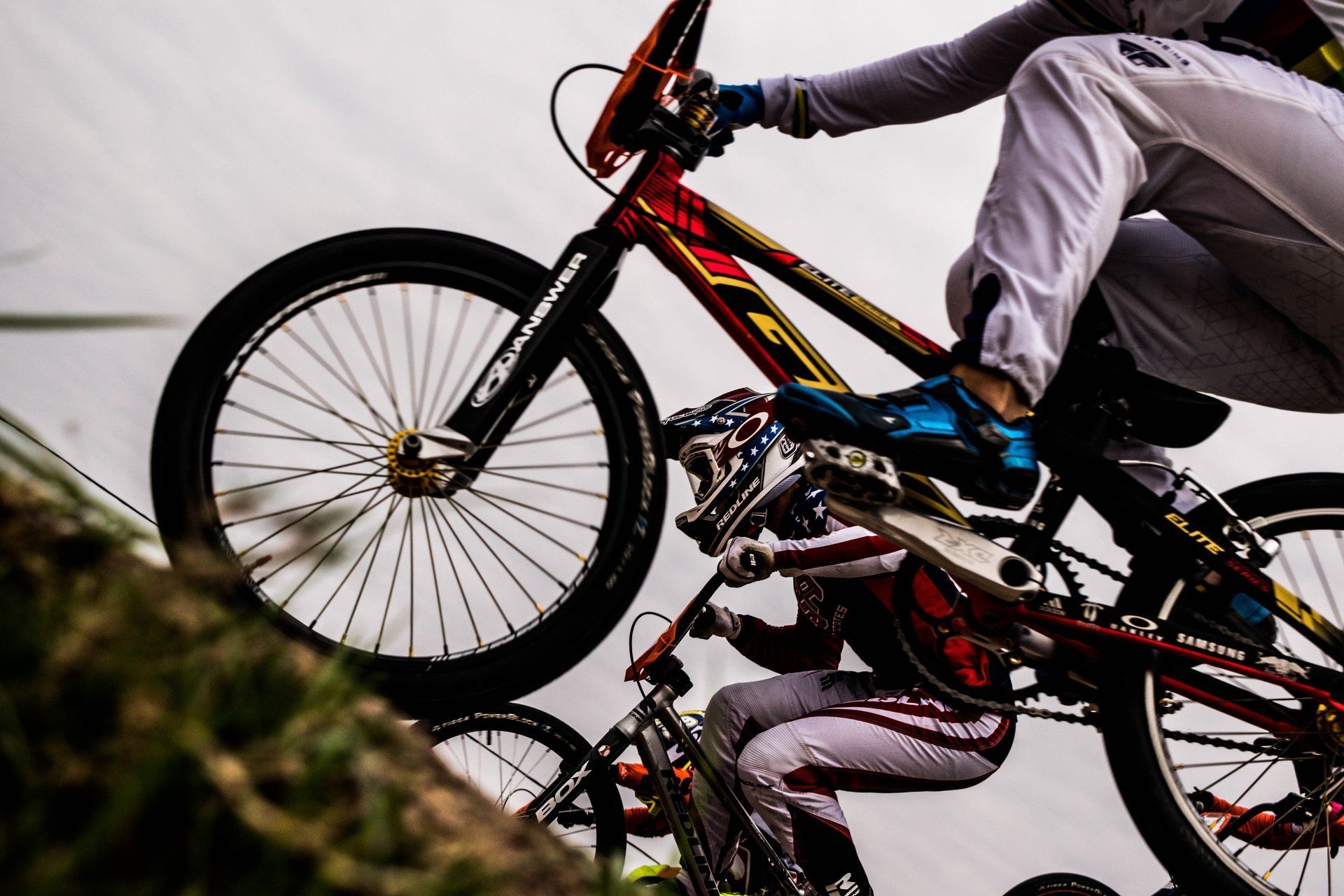 A person is riding a bike on top of another person 's bike.