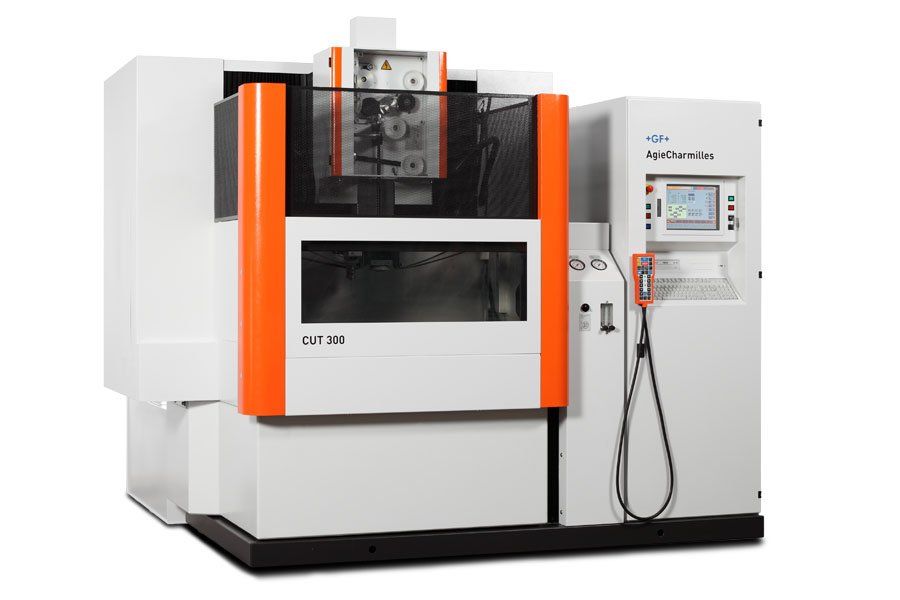 A white and orange machine is sitting on a white surface.