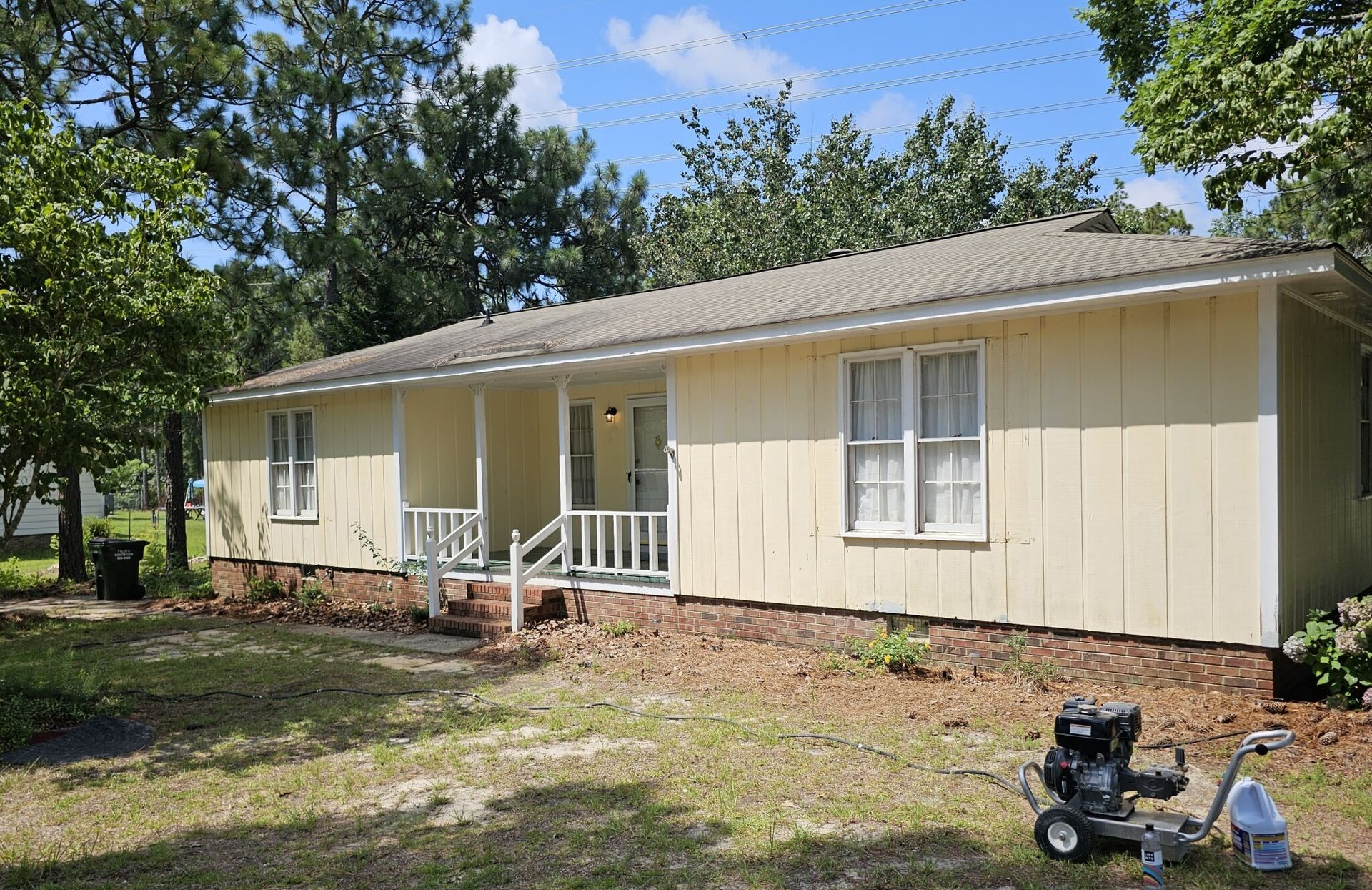 A blue wall with gold circles, next to an open door into a cafeteria with tables and flags.