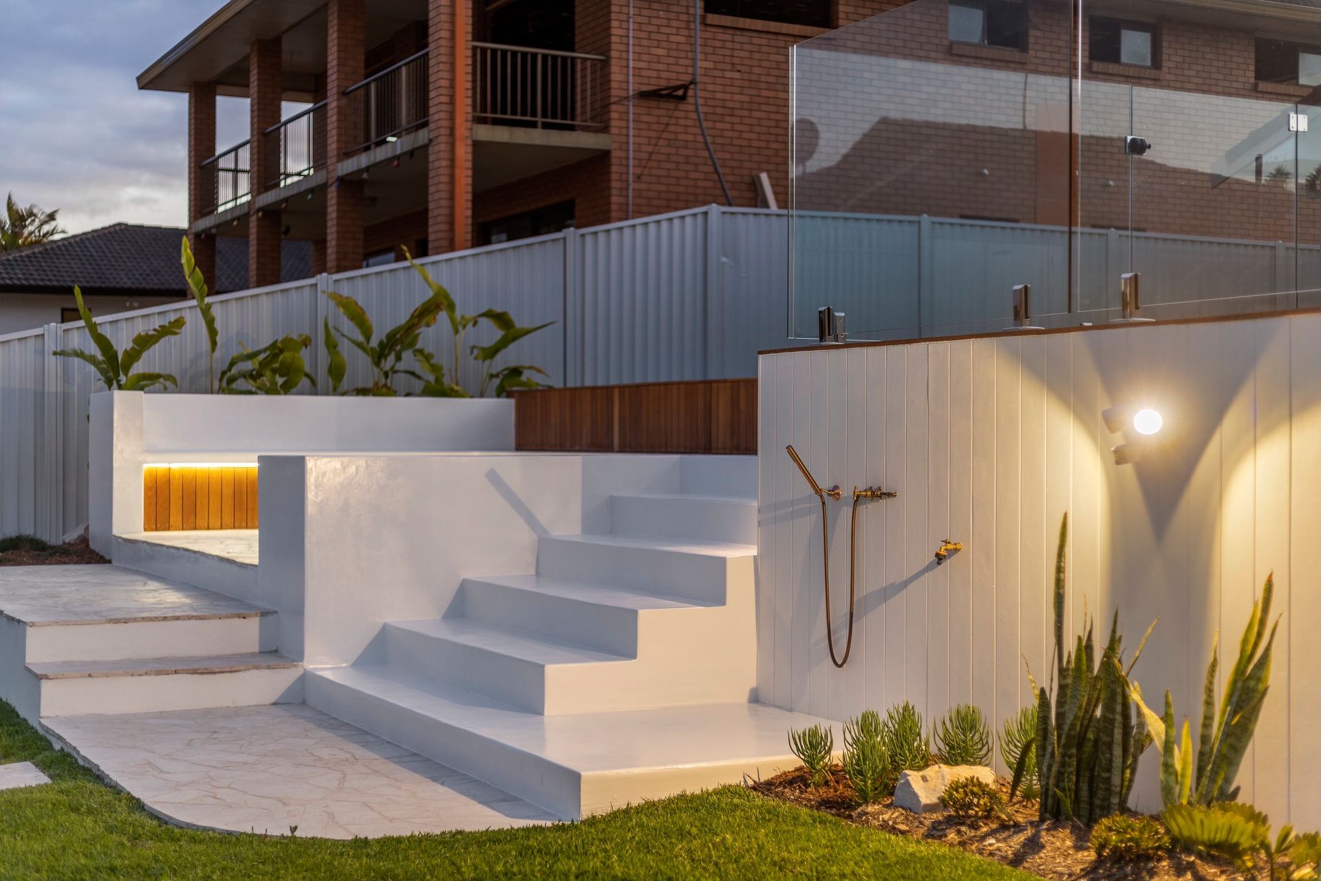 Rendered concrete steps in a landscaped backyard - Landscaping Gold Coast