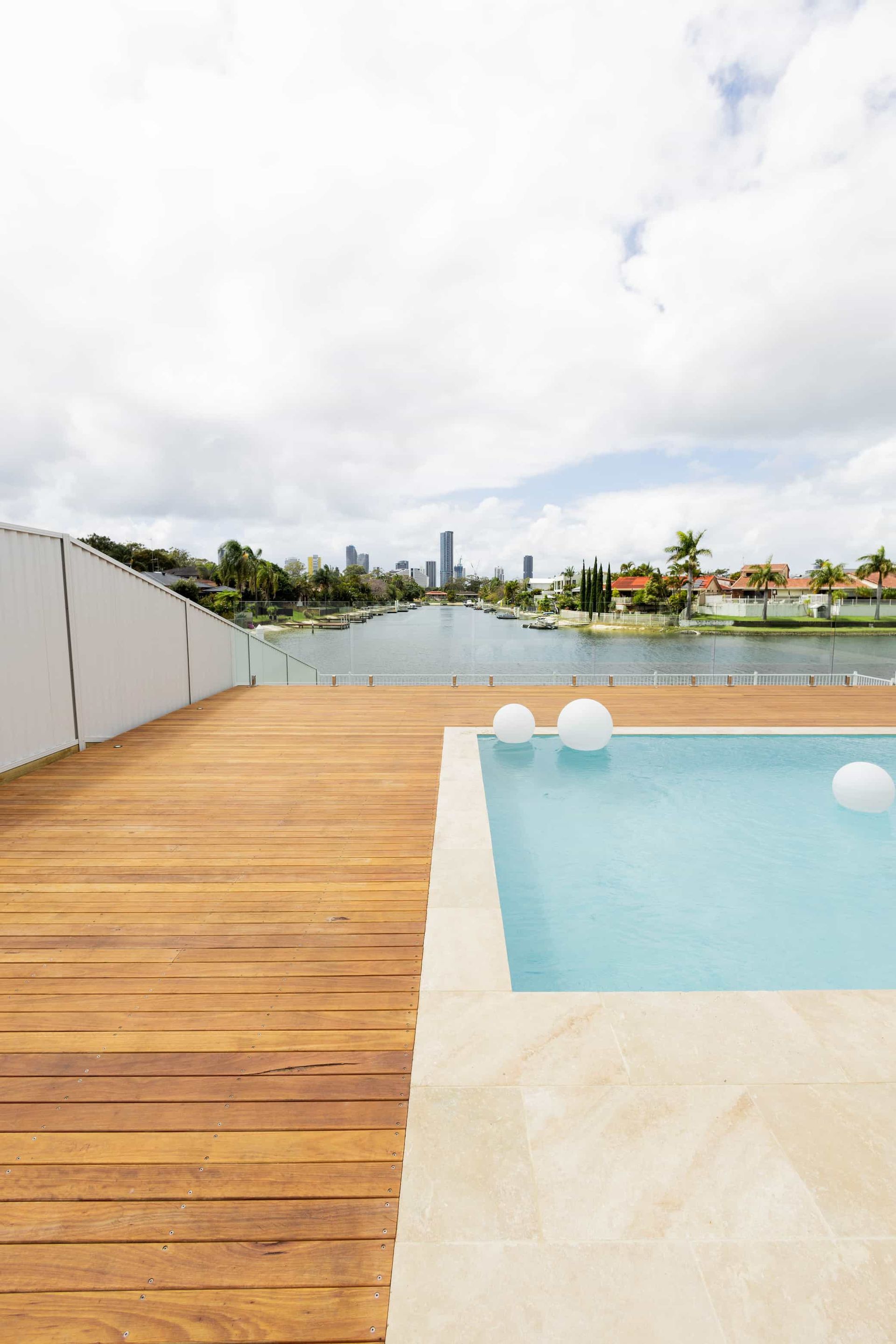 a large swimming pool is surrounded by a wooden deck