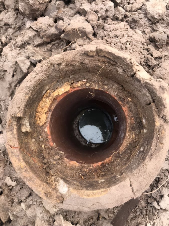 A Close Up Of A Hole In The Ground With Water In It — Casino Plumbing In Casino, NSW