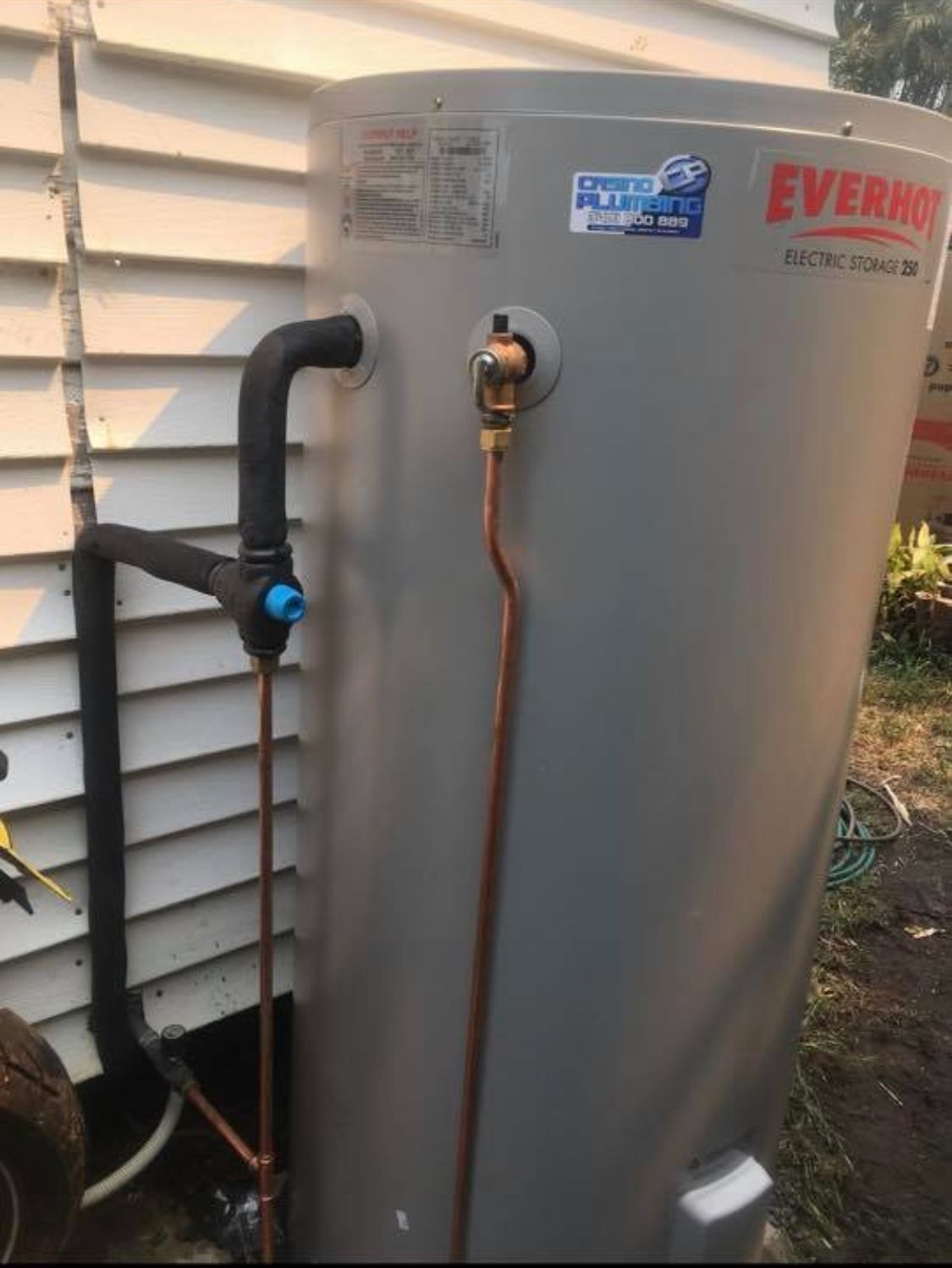 A Water Heater Is Attached To The Side Of A House — Casino Plumbing In Casino, NSW