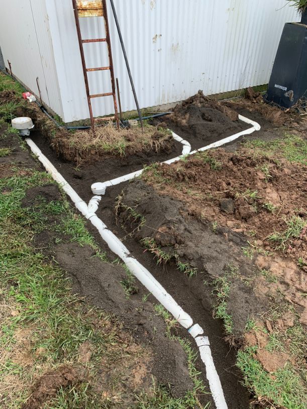 A Drainage System Is Being Installed In A Backyard — Casino Plumbing In Casino, NSW