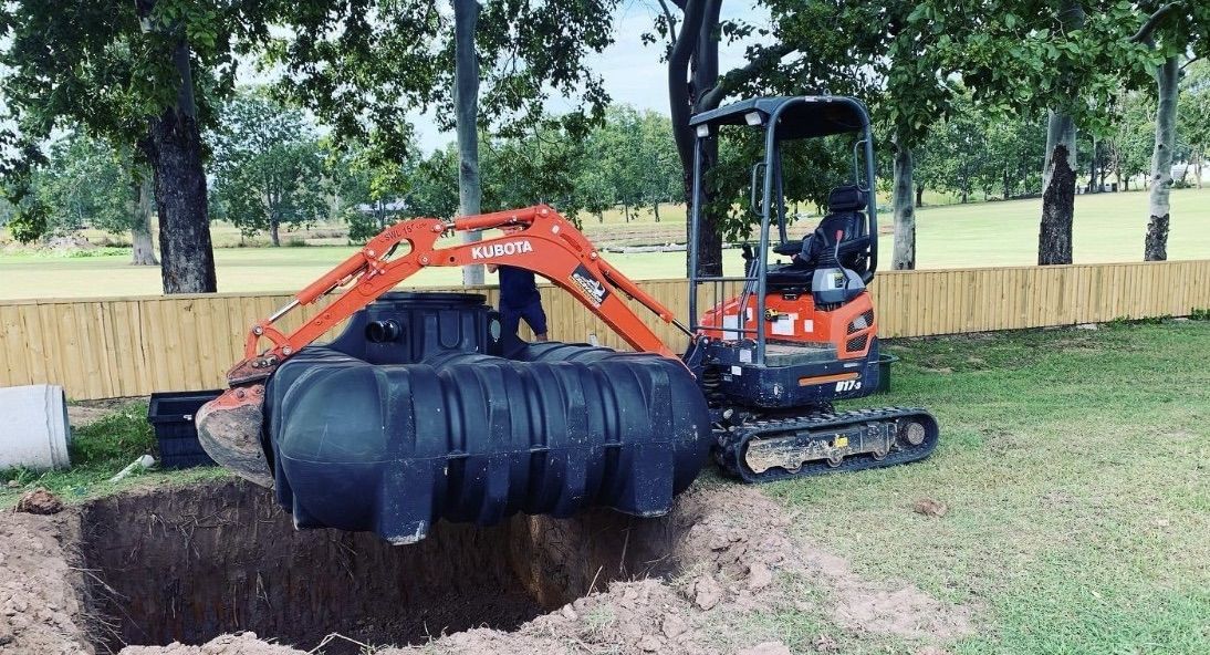 A Pipe Is Hanging From The Ceiling Of A Building Under A Bridge — Casino Plumbing In Casino, NSW