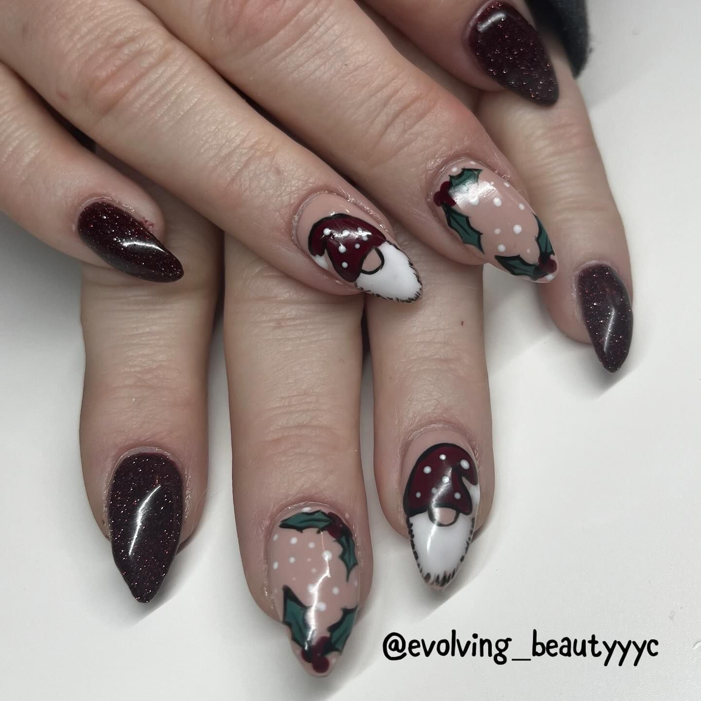 A close up of a woman 's nails with a gnome design