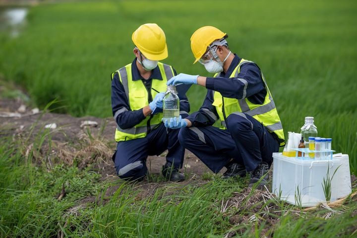 Environmental researchers investigate the condition of canal water for toxic spills.