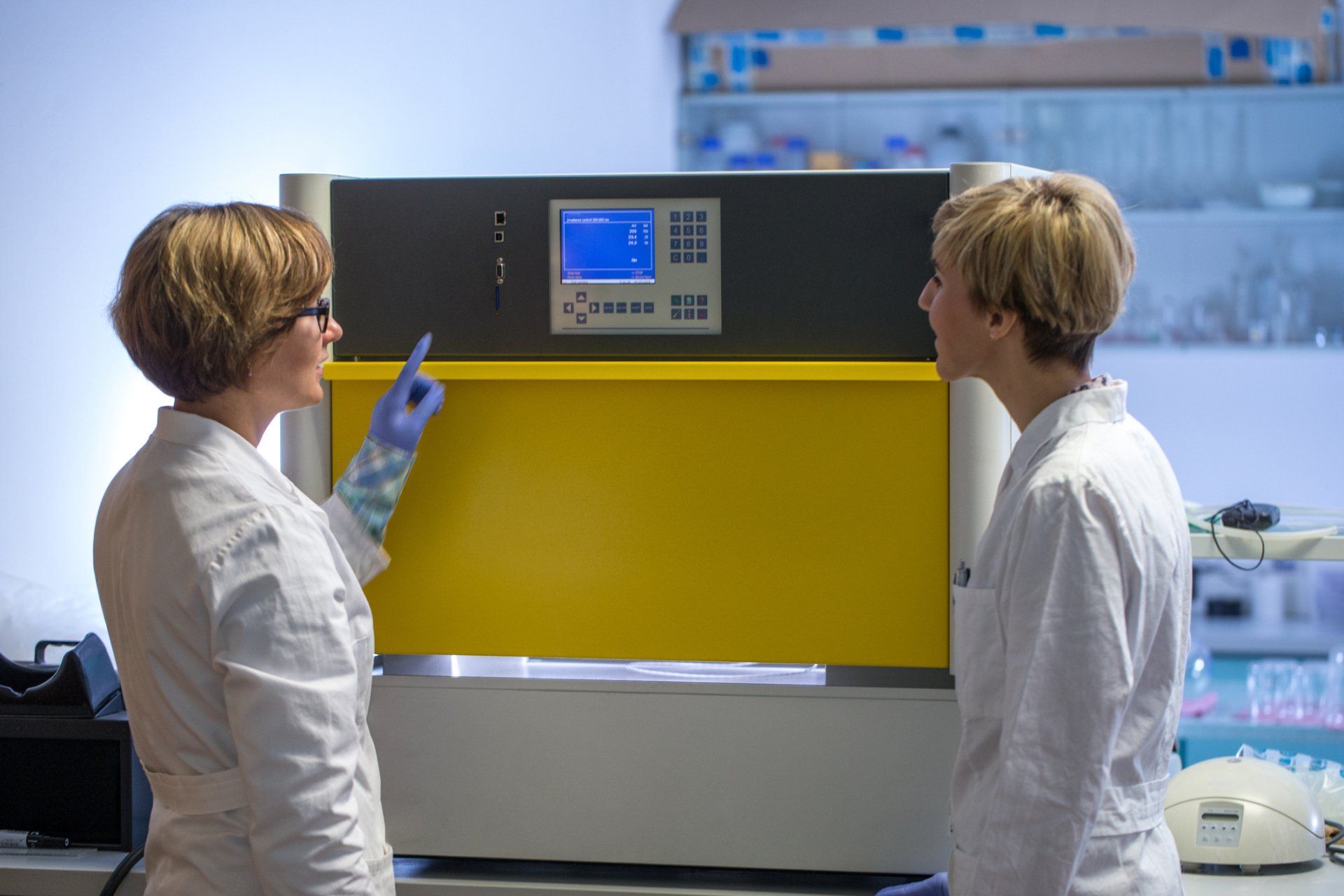 Women in white coats in a lab.