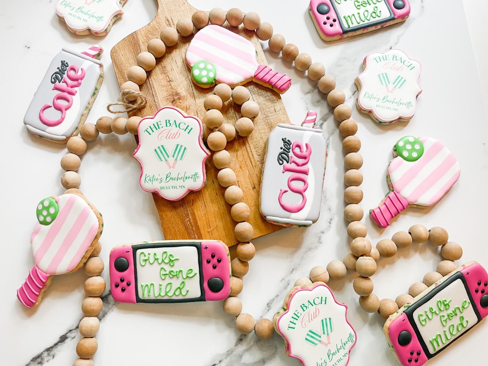 Cookies decorated as ping pong paddles, soda cans, and game consoles.