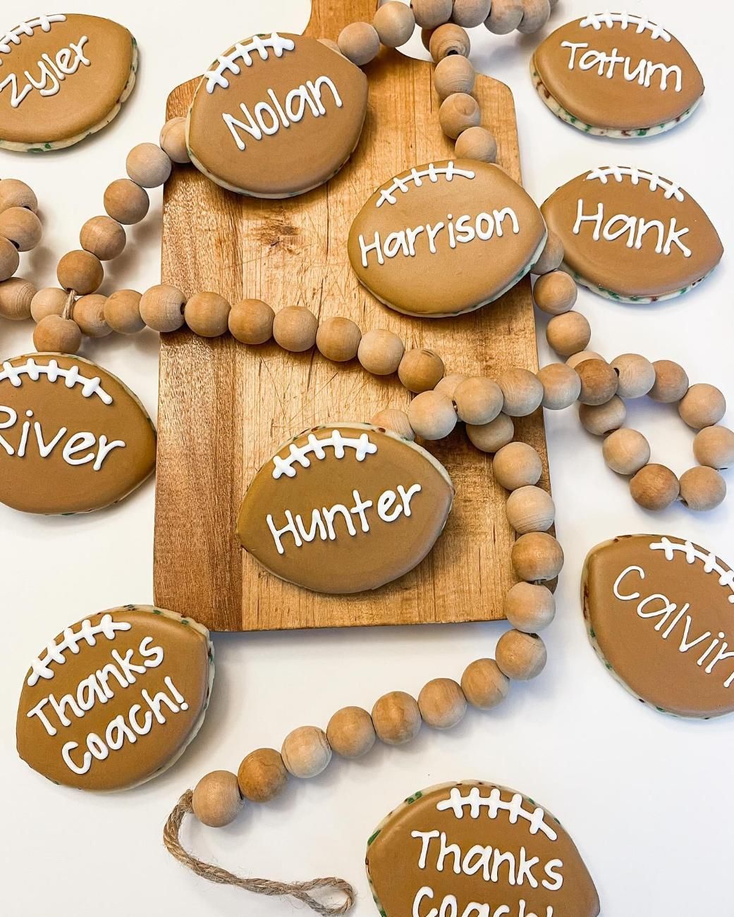 Football-shaped cookies with names and 