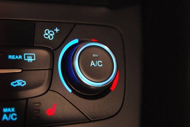 A close up of the a/c button on a car
