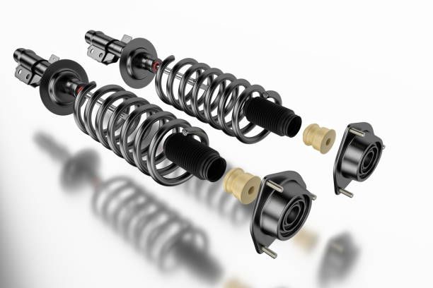 A pair of shock absorbers are sitting next to each other on a white surface.