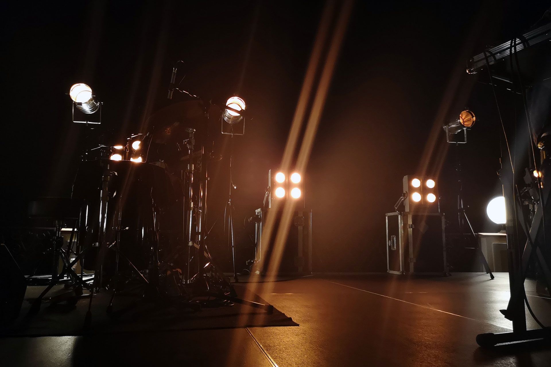 A dark stage with a lot of lights on it