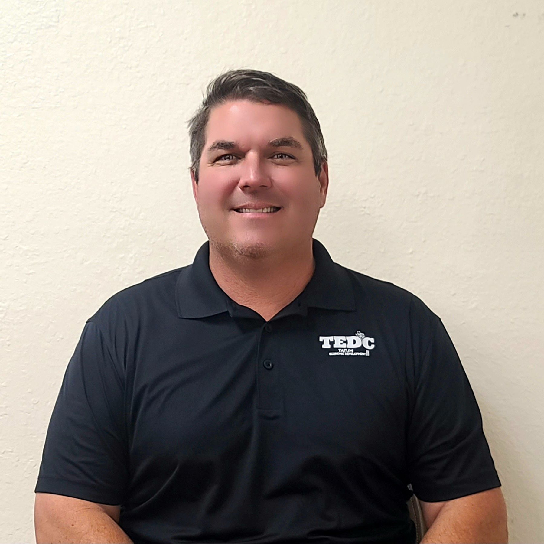 A man wearing a black shirt with the word trc on it