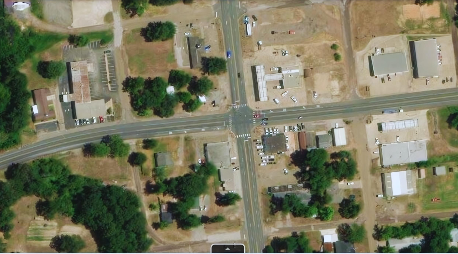 An aerial view of a small town with lots of buildings and trees