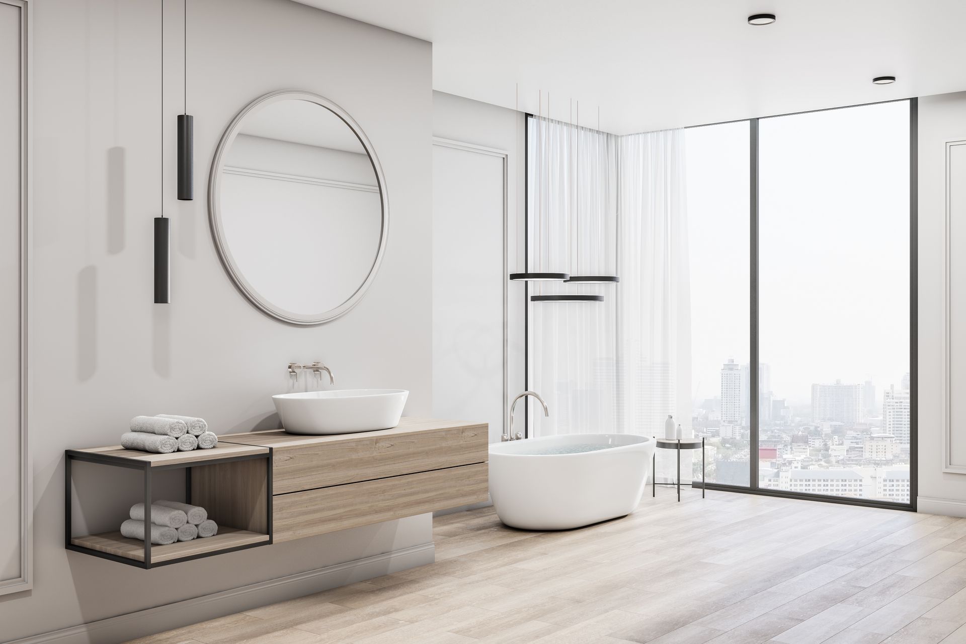 Modern, bright bathroom with a floating vanity, round mirror, freestanding tub, and city view.