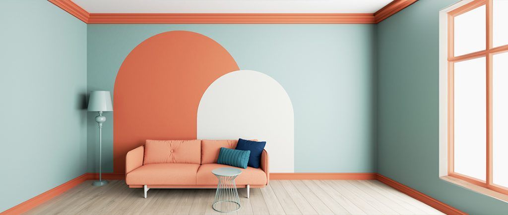 Interior room with teal walls, coral accents, coral sofa, and arched wall decor.