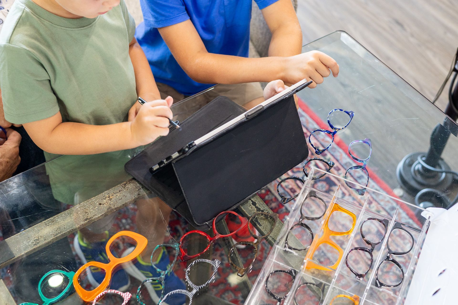 Young clients selecting children's eyewear at CustomEyes