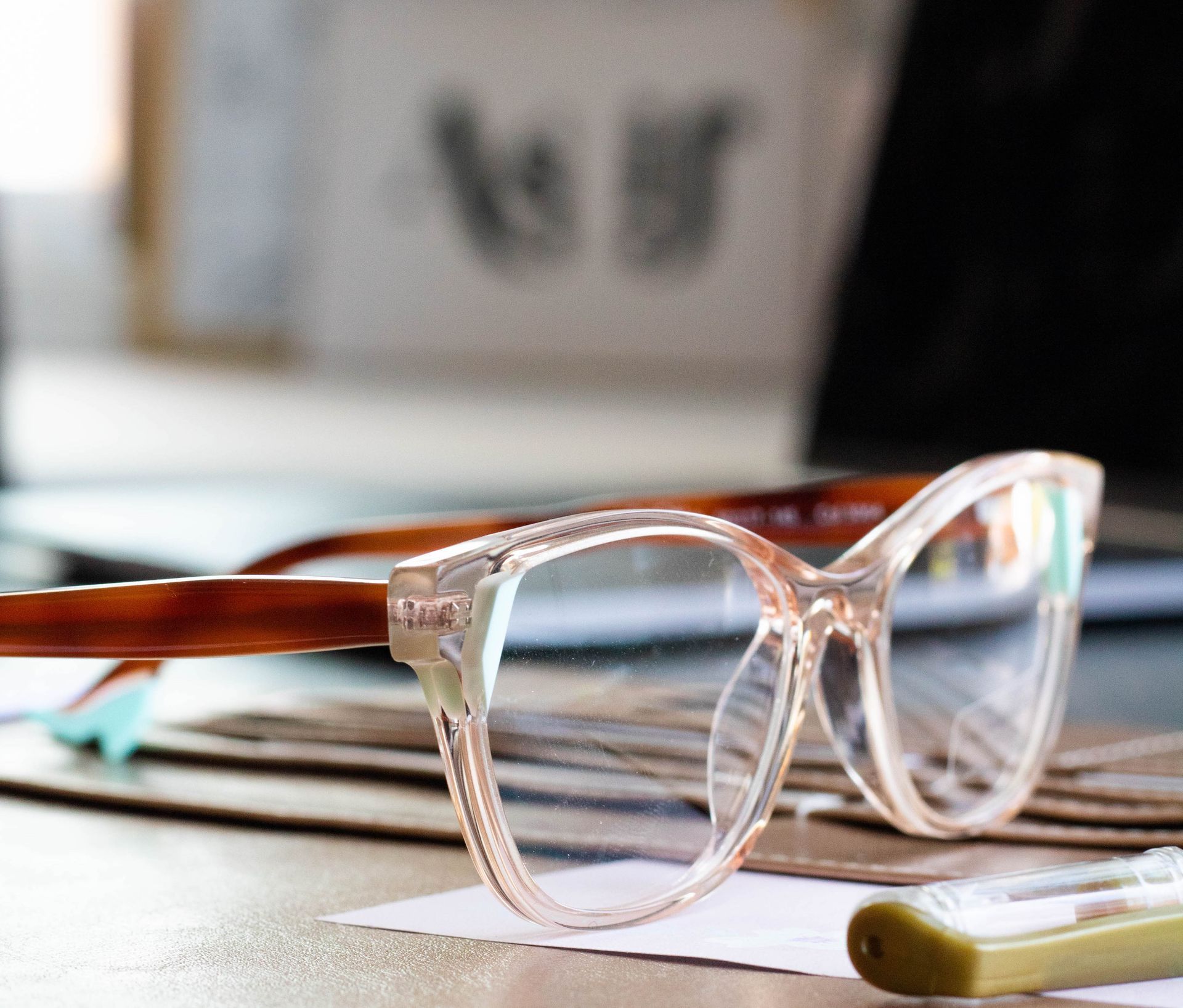 Blue light glasses from CustomEyes beside an open laptop for protection during the digital workday