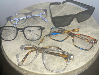 variety of broken glasses and sunglasses frames
