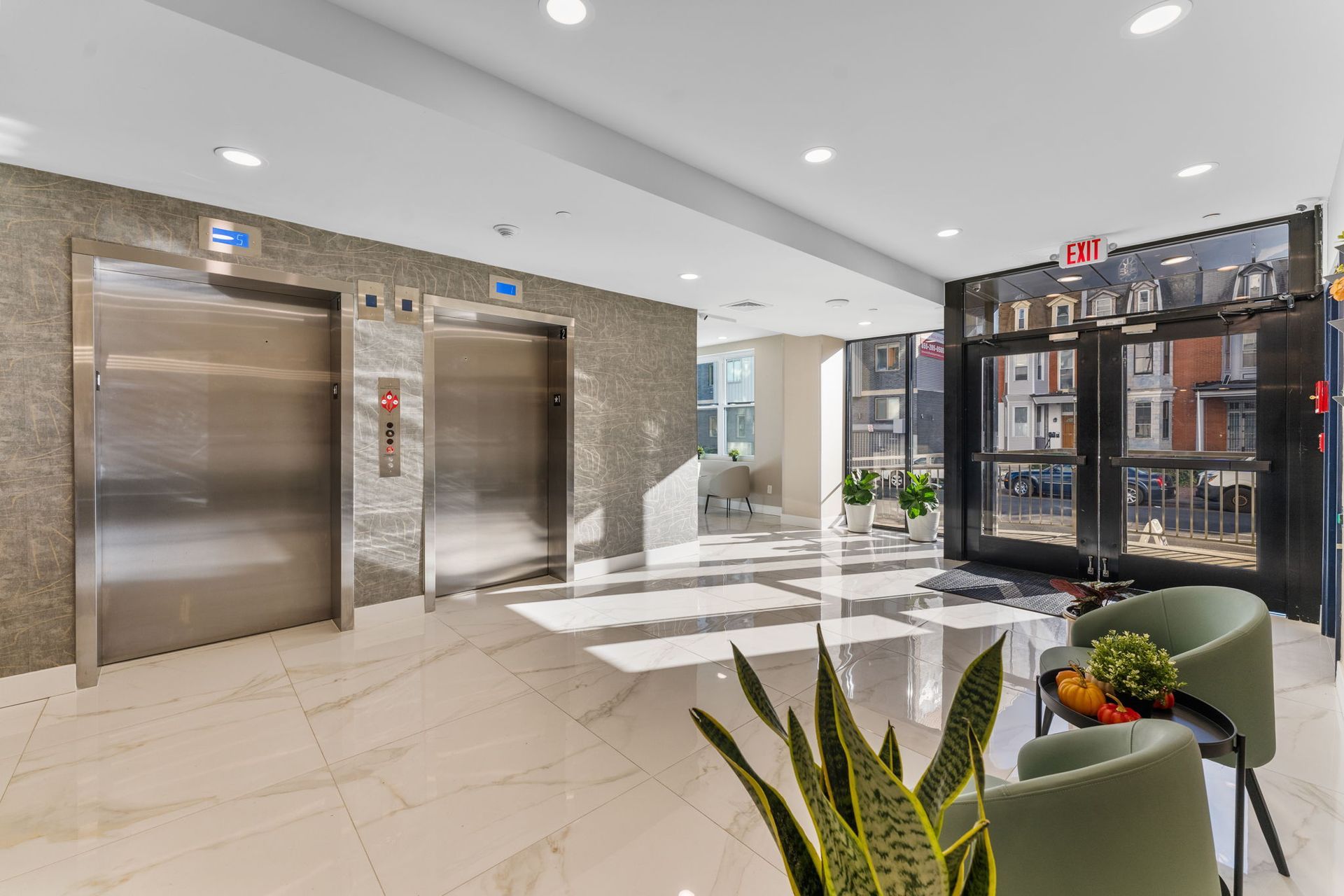 There are two elevators in the lobby of a building.