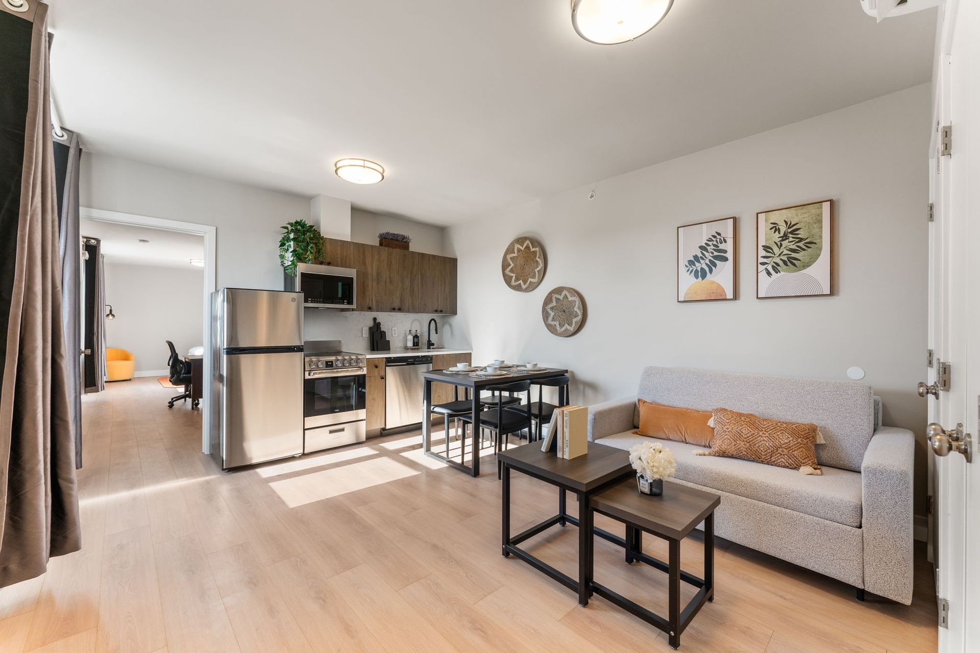 A living room with a couch , table , and refrigerator