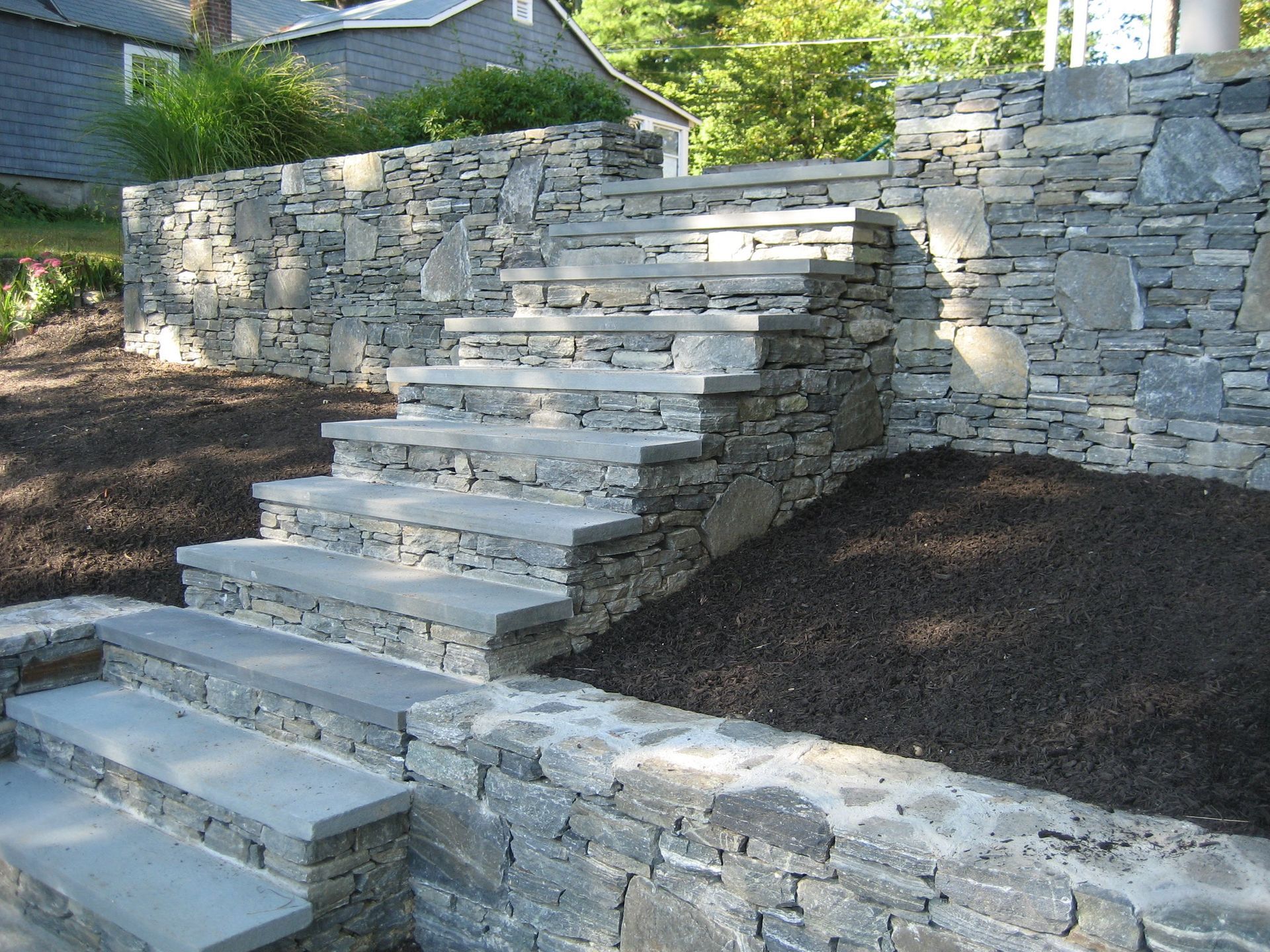 A stone wall with stairs leading up to it