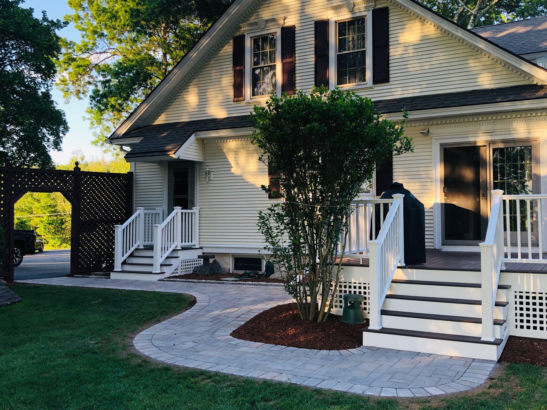 A white house with a porch and stairs