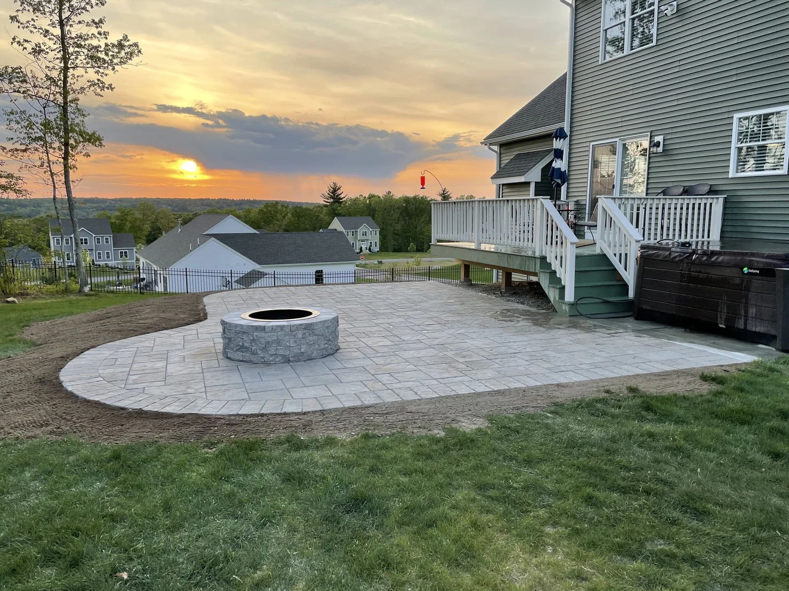 There is a fire pit in the backyard of a house.