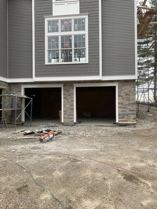 A house is being built with a garage underneath it.