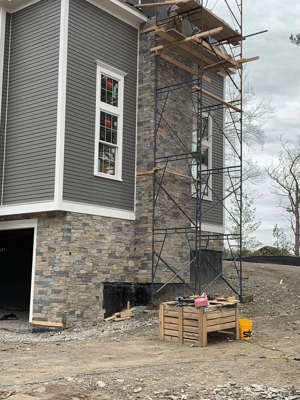A house is being built with scaffolding around it.