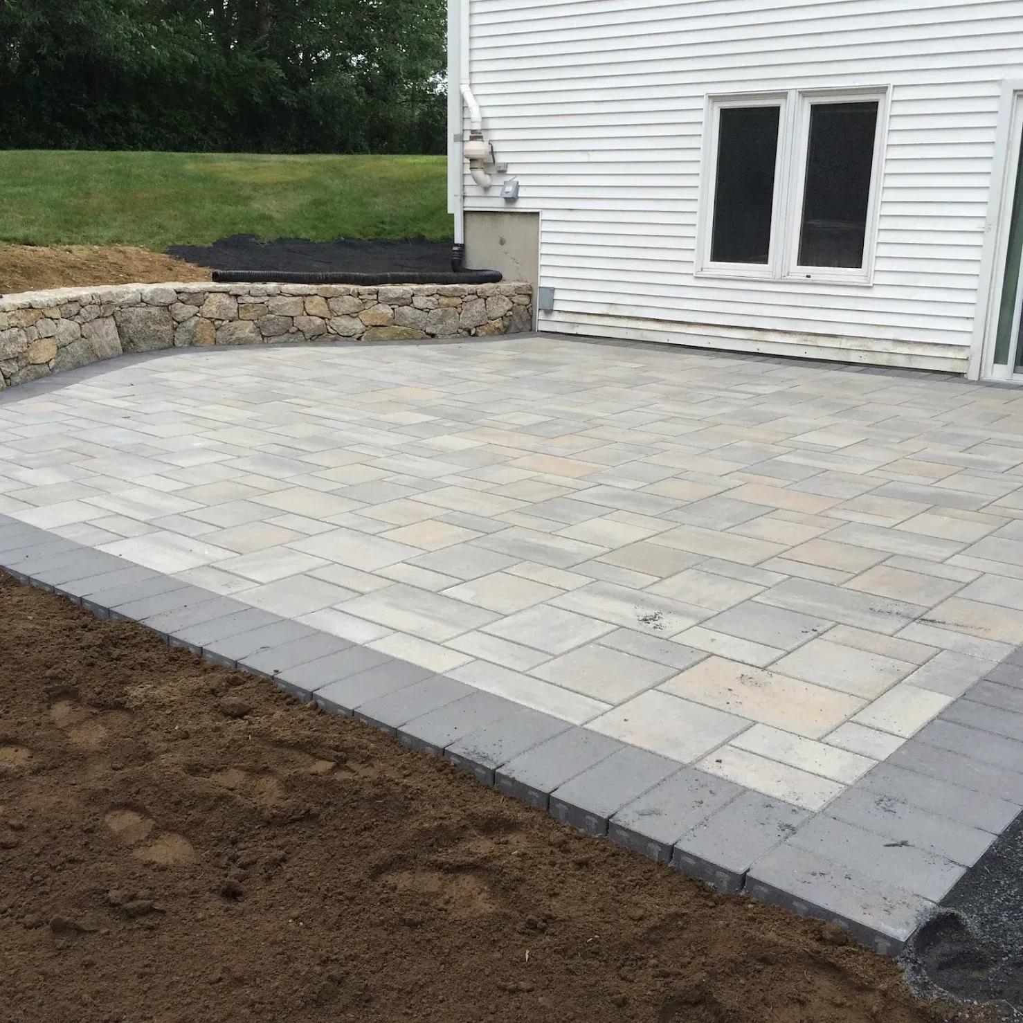 A white house with a patio in front of it