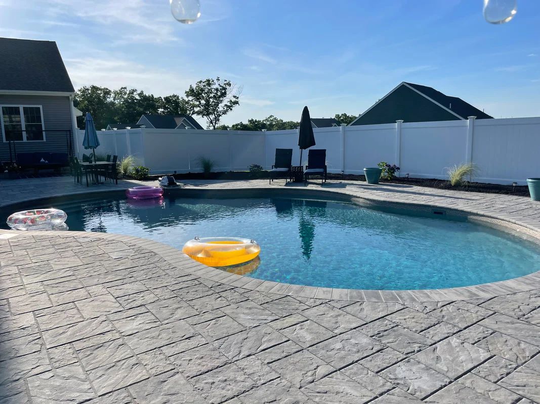 A large swimming pool with a yellow life preserver in it.
