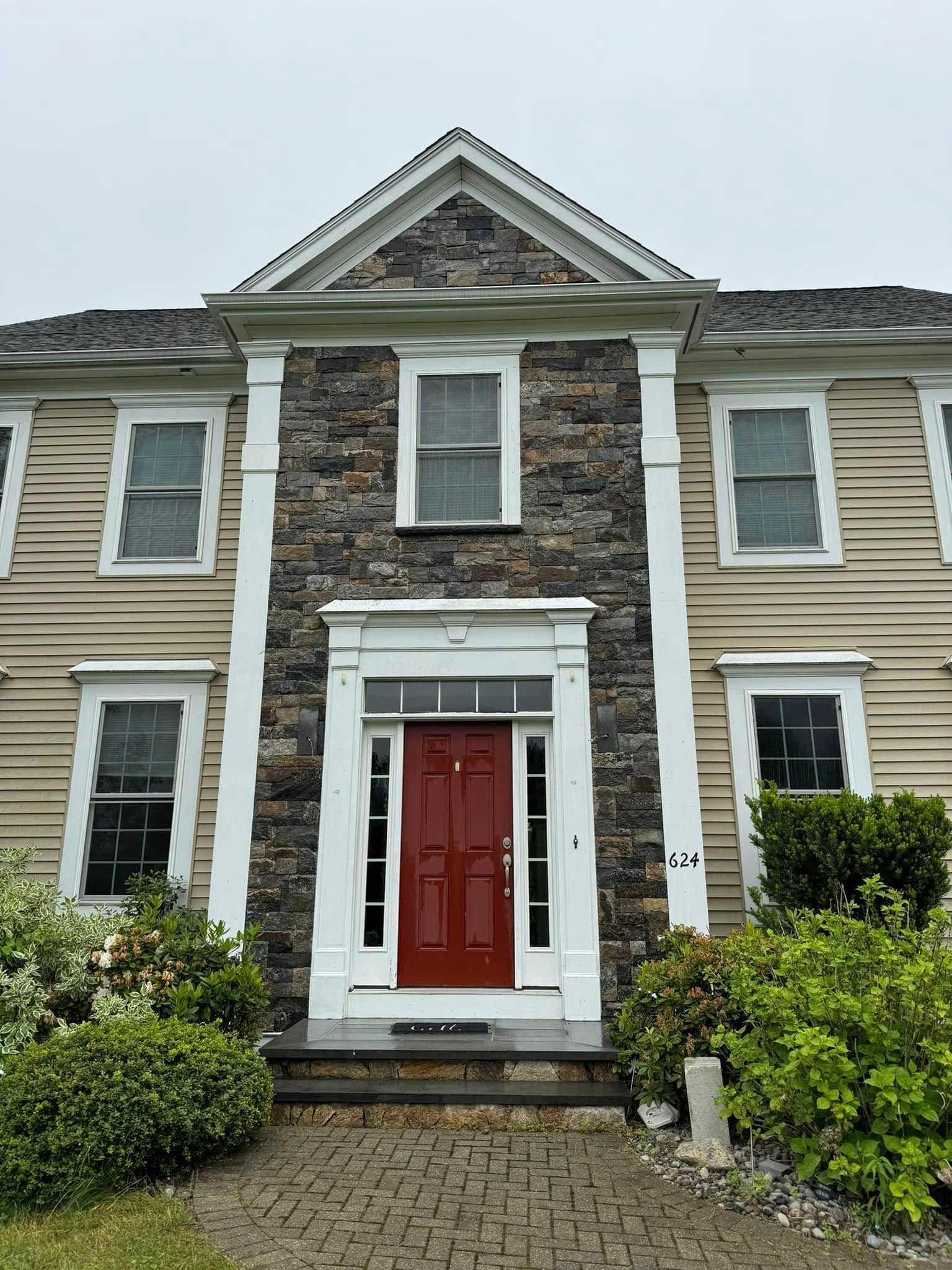 A large house with a red door and white trim