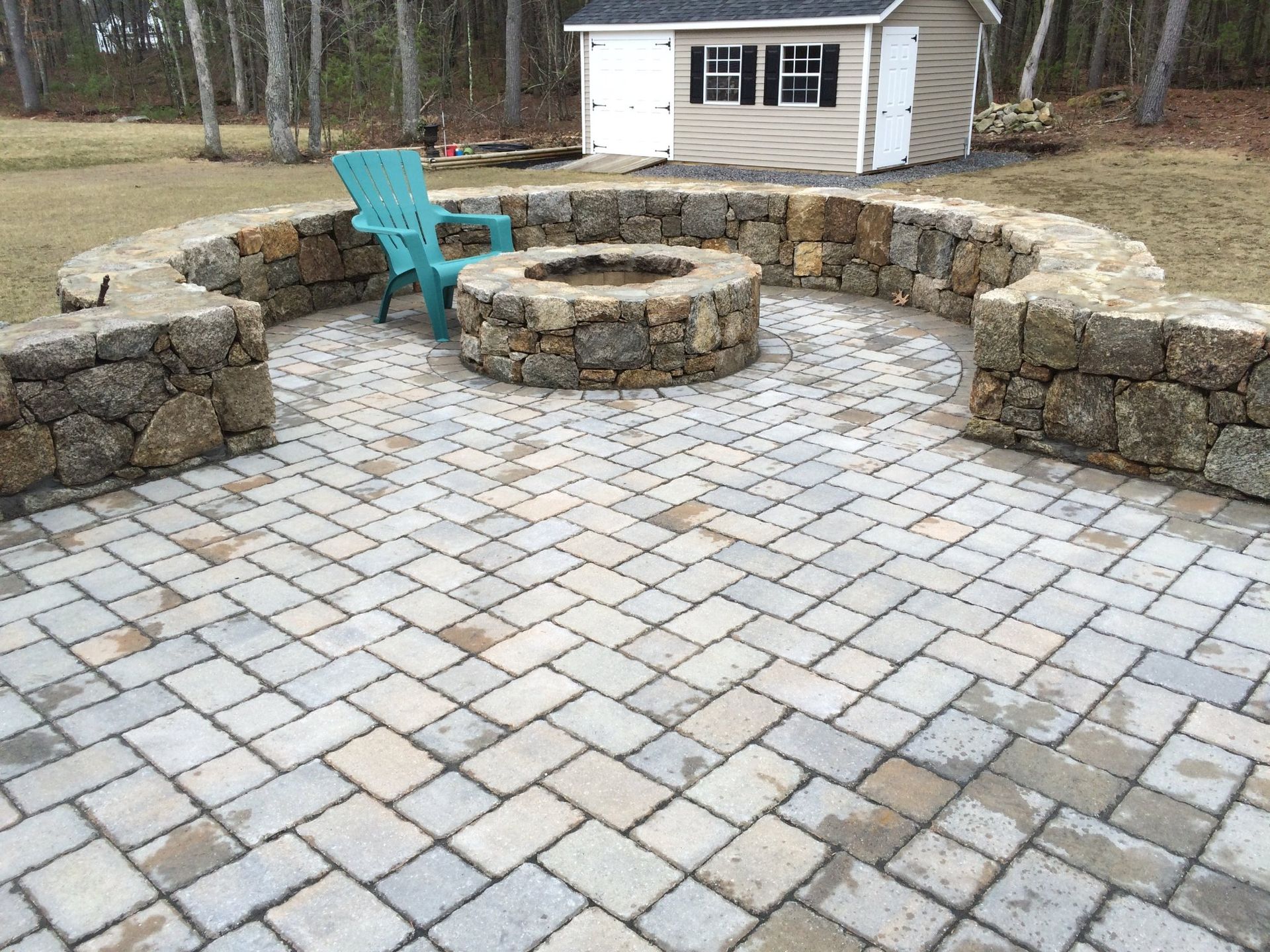 There is a fire pit in the middle of the patio.
