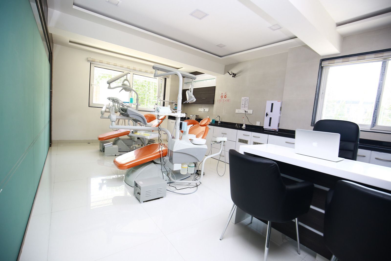 A person carries a blue bucket filled with cleaning supplies through a busy, blurred public walkway.