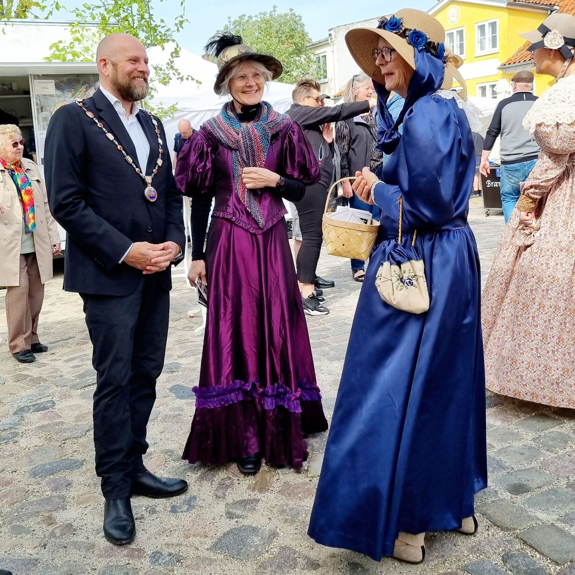 Borgmesteren med to kvinder i flotte traditionelle dragter til Gyldne Dage i Præstø.